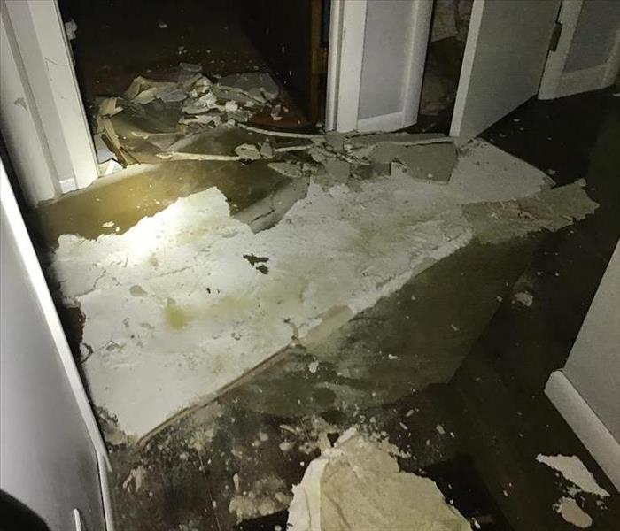 crumbled drywall on top of soaking wet flooring