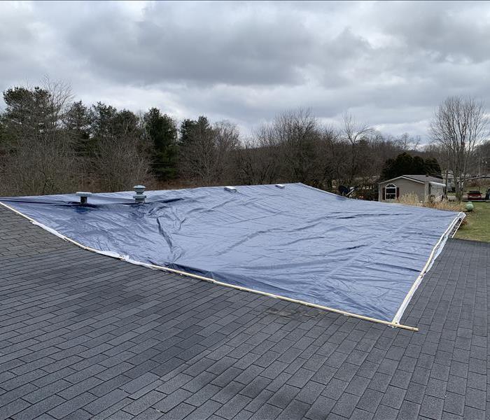 Photo of a roof after tarping